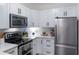 Modern white kitchen with stainless steel appliances at 206 E South St # 6031, Orlando, FL 32801