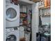 Stackable washer and dryer, shelving, and additional storage in closet at 206 E South St # 6031, Orlando, FL 32801