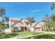 Two-story house with beige siding, brown roof, and a two-car garage at 2102 Country Side Dr, Apopka, FL 32712