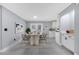 Formal dining room features a marble dining table and chairs, adjacent to the kitchen at 272 Iowa Woods W Cir, Orlando, FL 32824