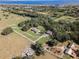 Aerial view of property showing home, expansive pastures, and surrounding landscape at 2850 Horton Rd, Kissimmee, FL 34744
