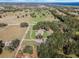 Aerial view of property showing home, expansive pastures, and surrounding landscape at 2850 Horton Rd, Kissimmee, FL 34744