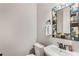Small bathroom with pedestal sink and colorful mirror at 2850 Horton Rd, Kissimmee, FL 34744