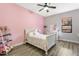 Charming bedroom with pink walls and a white sleigh bed at 2850 Horton Rd, Kissimmee, FL 34744