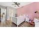 Bedroom with a white sleigh bed, en-suite bathroom access, and view of backyard at 2850 Horton Rd, Kissimmee, FL 34744