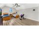 Bright bedroom with two twin beds, a ceiling fan, and wood flooring at 2850 Horton Rd, Kissimmee, FL 34744