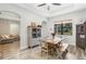 Bright dining room features a rustic wooden table with bench seating, and a view into the living room at 2850 Horton Rd, Kissimmee, FL 34744