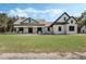 Two-story house with stone accents, a large front porch, and a spacious lawn at 2850 Horton Rd, Kissimmee, FL 34744
