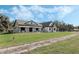 House with stone and stucco exterior, a covered porch, and a long driveway at 2850 Horton Rd, Kissimmee, FL 34744