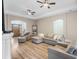 Spacious living room with hardwood floors, fireplace, and sectional sofa at 2850 Horton Rd, Kissimmee, FL 34744