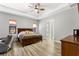Spacious main bedroom with wood flooring, large bed, and ceiling fan at 2850 Horton Rd, Kissimmee, FL 34744
