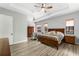 Main bedroom with wood floors, king-size bed and en-suite bathroom access at 2850 Horton Rd, Kissimmee, FL 34744
