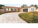 Brick ranch house with attached garage and landscaped lawn at 2855 Cady Way, Winter Park, FL 32792