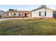 One-story home with gray siding, landscaping, and a curved driveway at 2855 Cady Way, Winter Park, FL 32792