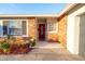 Brick ranch house with red front door and landscaped yard at 2855 Cady Way, Winter Park, FL 32792