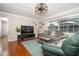 Spacious living area with hardwood floors, comfy seating, and a large TV at 2855 Cady Way, Winter Park, FL 32792