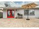 Brick patio with red doors and outdoor furniture at 2855 Cady Way, Winter Park, FL 32792