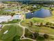 Aerial view of community, golf course, and lake at 2923 Marshfield Ct # Ge, Orlando, FL 32822