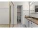 Bathroom featuring vanity, toilet, tile flooring, closet, and an open doorway at 2923 Marshfield Ct # Ge, Orlando, FL 32822