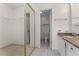 Bathroom view with vanity, toilet, tile flooring, closet, and an open doorway at 2923 Marshfield Ct # Ge, Orlando, FL 32822