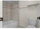 Bathroom view featuring tub and tiled shower, toilet, and towel bar at 2923 Marshfield Ct # Ge, Orlando, FL 32822