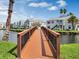 Wooden footbridge over canal, offering scenic views of community at 2923 Marshfield Ct # Ge, Orlando, FL 32822