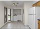 Open kitchen area featuring tiled floors, a window, and convenient access to laundry facilities at 2923 Marshfield Ct # Ge, Orlando, FL 32822