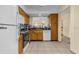 Galley-style kitchen with wood cabinets, granite counters, and white appliances at 2923 Marshfield Ct # Ge, Orlando, FL 32822