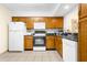 L-shaped kitchen with wood cabinets, granite counters and a dishwasher at 2923 Marshfield Ct # Ge, Orlando, FL 32822