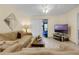 Living room with a beige couch, coffee table, and a view of the patio at 2923 Marshfield Ct # Ge, Orlando, FL 32822