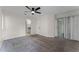 Spacious main bedroom with carpeted floors, a ceiling fan, ensuite bath, and sliding glass doors at 2923 Marshfield Ct # Ge, Orlando, FL 32822