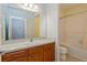 Clean bathroom, wood vanity, bathtub, and shower at 306 Quarry Rock Cir, Kissimmee, FL 34758