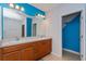 Double vanity bathroom with blue walls and a mirror at 306 Quarry Rock Cir, Kissimmee, FL 34758