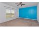 Bedroom with blue accent wall and window at 306 Quarry Rock Cir, Kissimmee, FL 34758