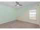 Bedroom with two-toned walls, ceiling fan, and window at 306 Quarry Rock Cir, Kissimmee, FL 34758