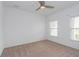 Bright bedroom with neutral walls, carpet, and two windows at 306 Quarry Rock Cir, Kissimmee, FL 34758