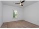 Spacious bedroom featuring a window and ceiling fan at 306 Quarry Rock Cir, Kissimmee, FL 34758