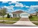 Charming single-story home featuring a well-manicured lawn, neutral exterior paint, and a two-car garage with driveway at 306 Quarry Rock Cir, Kissimmee, FL 34758