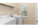 Laundry room with washer, dryer, and shelving at 3181 Winding Trl, Kissimmee, FL 34746