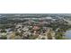 Aerial view showing home's location near a lake and main road at 32650 Azealia Pl, Tavares, FL 32778