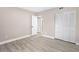 Bright bedroom with ample closet space and wood-look floors at 32650 Azealia Pl, Tavares, FL 32778