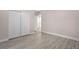 Spacious bedroom with mirrored closet doors and wood-look floors at 32650 Azealia Pl, Tavares, FL 32778