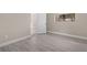 Simple bedroom with grey wood-look flooring and access to a bathroom at 32650 Azealia Pl, Tavares, FL 32778
