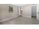 Bright bedroom with grey wood-look flooring and a closet at 32650 Azealia Pl, Tavares, FL 32778