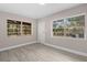 Bedroom with backyard views and wood-look floors at 32650 Azealia Pl, Tavares, FL 32778