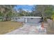 Newly renovated house with gray exterior, landscaping, and driveway at 32650 Azealia Pl, Tavares, FL 32778