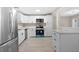 Modern kitchen with white cabinets and new appliances at 32650 Azealia Pl, Tavares, FL 32778