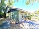 View of the backyard featuring a well-maintained lawn, mature trees, and a patio area ideal for outdoor entertaining at 3421 Fudge Rd, Apopka, FL 32712