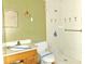 Outdated bathroom featuring a vanity with damaged cabinets and a tiled shower with decorative palm tree accents at 3421 Fudge Rd, Apopka, FL 32712