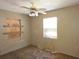 Bedroom featuring a window for natural light and boarded-up window; shows visible signs of needing repair and updating at 3421 Fudge Rd, Apopka, FL 32712